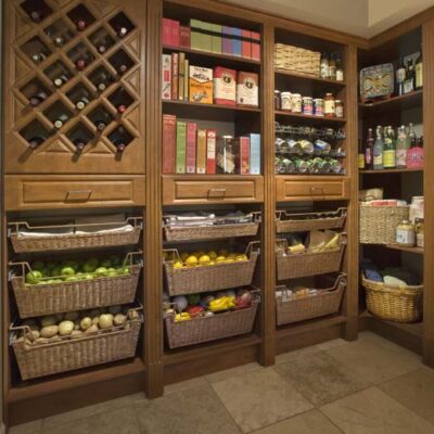 Custom Kitchen Pantry in Warm Cognac with Rattan Baskets and Decorative Trim